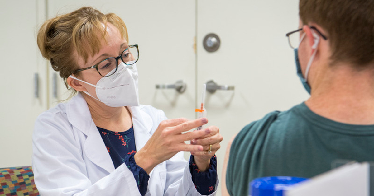 A public health worker wearing a mask prepares to adminster a COVID-19 vaccine at a vaccine clinic in November 2021 at Clayton Hall on the University of Delaware’s Newark campus.