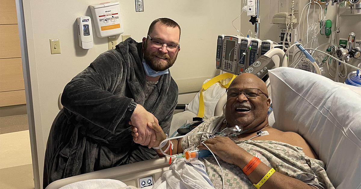 Tim Letts (left) who donated his kidney to Bill Sumiel (right) poses with him in Bill's hospital room following the transplant surgery.