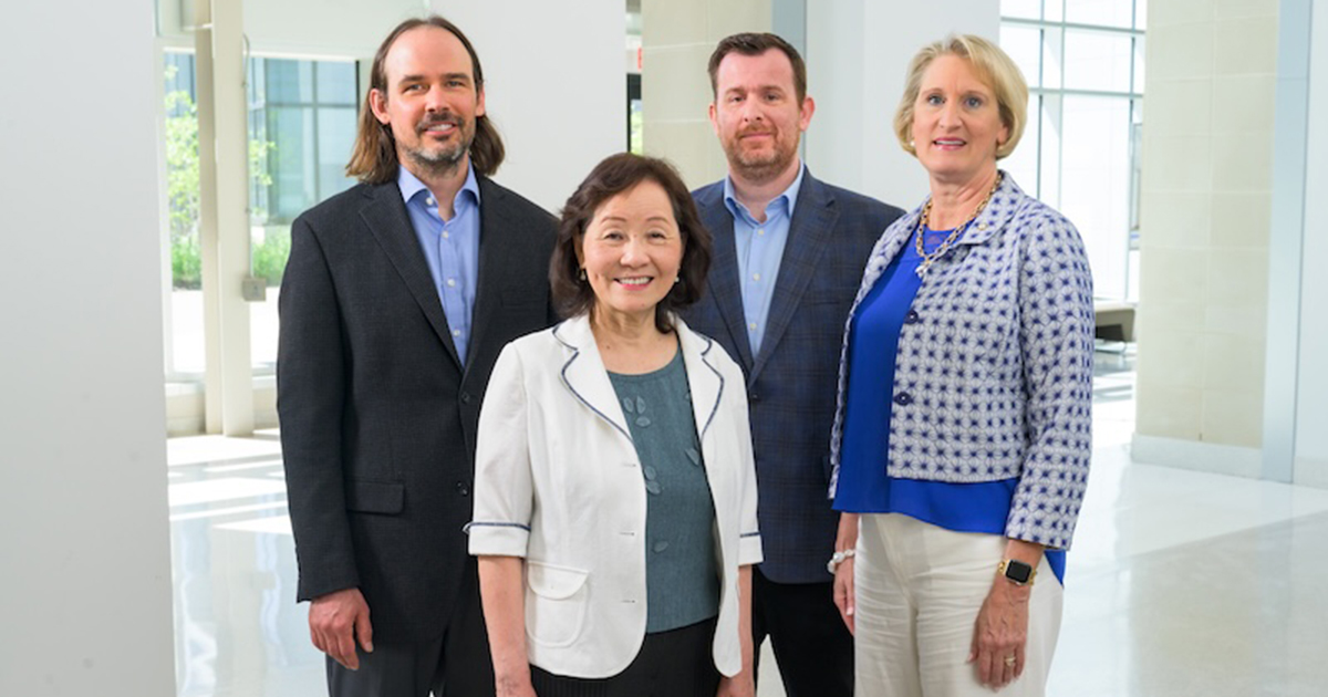 The new NSF AI Institute for Human-AI Cooperation (NSF HAIC) is led by UD’s Cathy Wu, Unidel Edward G. Jefferson Chair in Engineering and Computer Science, with Austin Brockmeier (back row left), deputy director and assistant professor of electrical and computer engineering, Panagiotis (Panos) Artemiadis, professor of mechanical engineering, and Darcy Reisman, chair of the Department of Physical Therapy. They are shown standing together here with a window behind them and white floor and walls. 