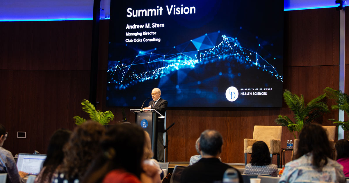 UD College of Arts and Sciences alumni Andrew M. Stern, Class of 1970, gives his vision for the Stern Summit at the podium on the stage in the Audion at STAR. Behind him is a large screen that says 