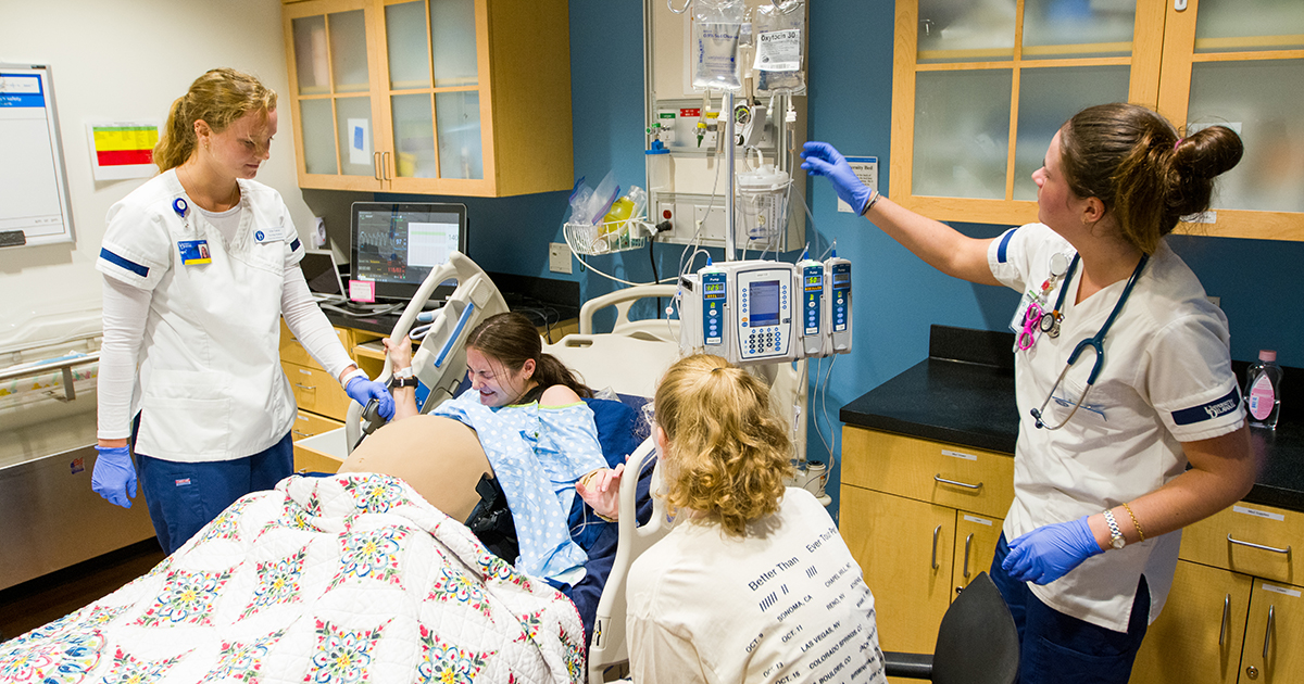 Nursing students take part in a maternity simulation.
