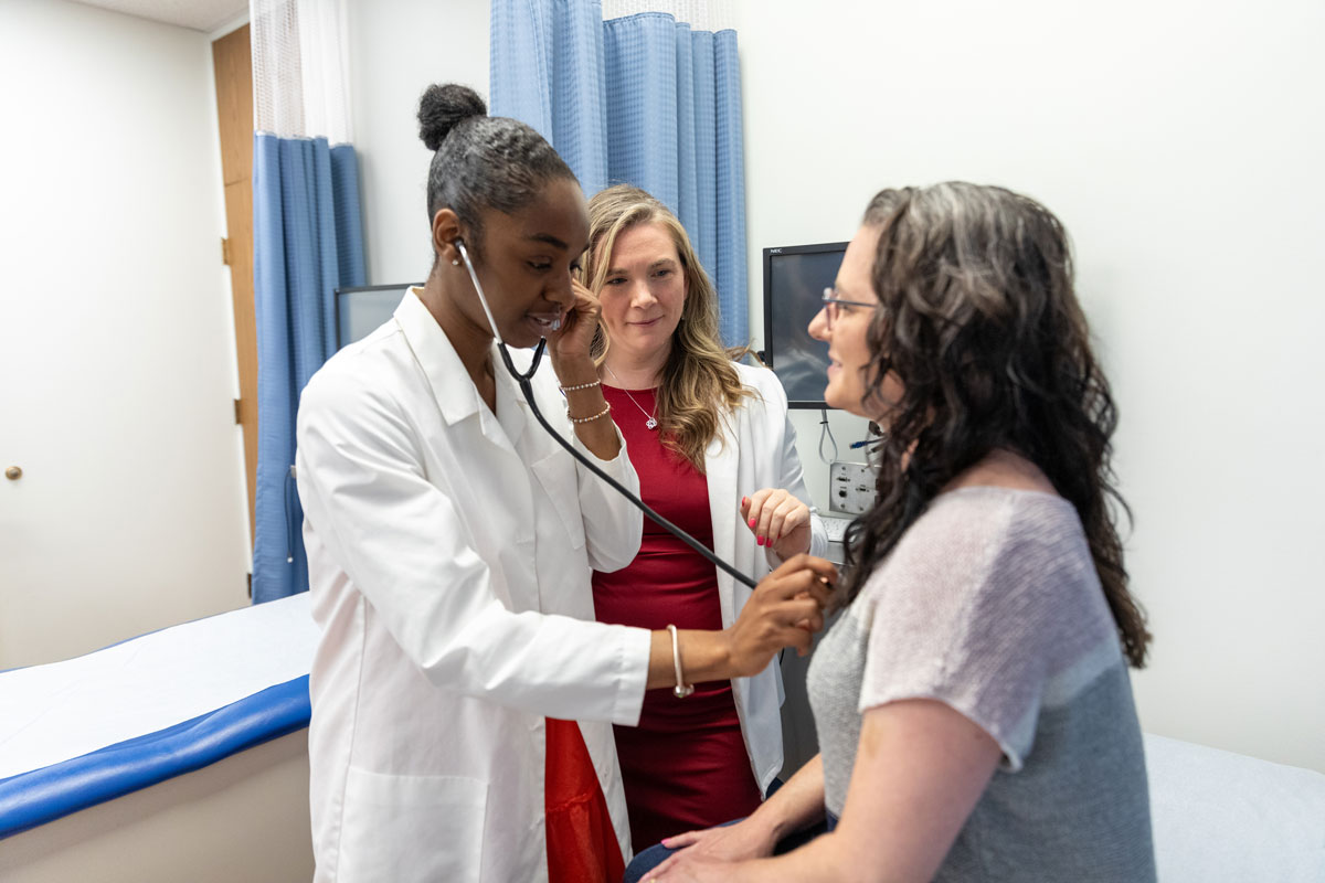 student and instructor reviewing document with patient