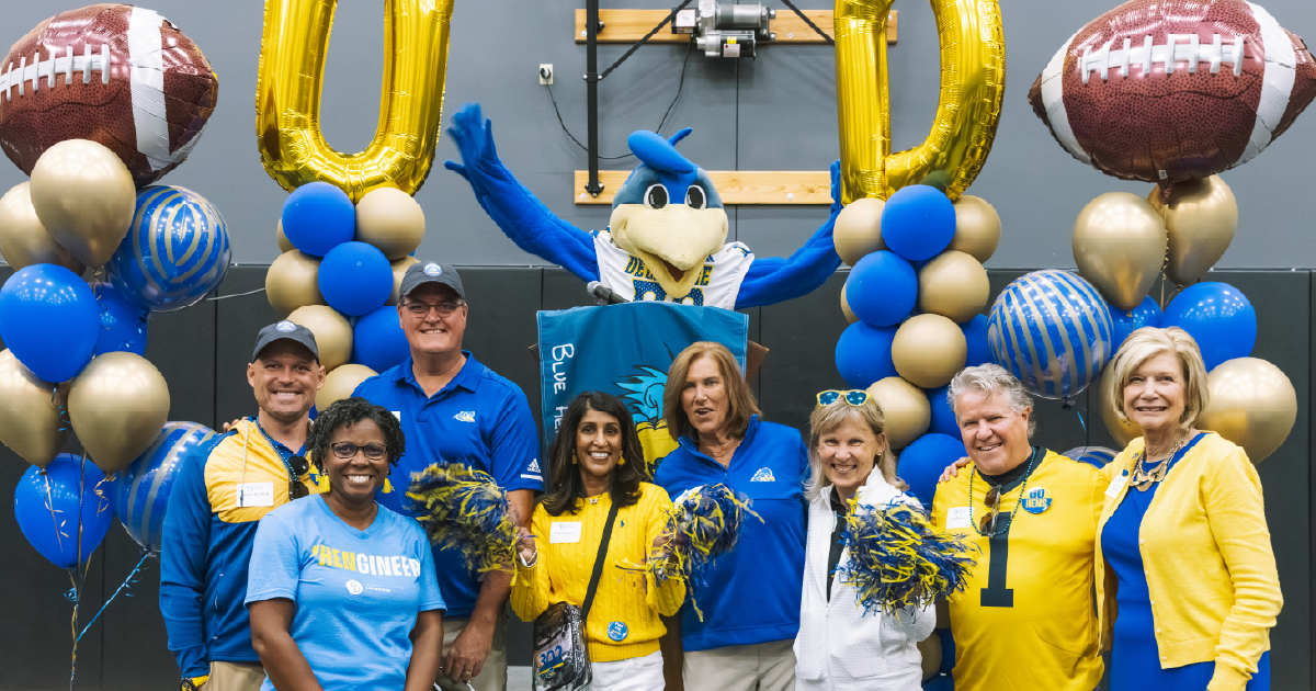 Blue Hens attending a Blue Hen Tailgate with YoUDee and President Carlson.