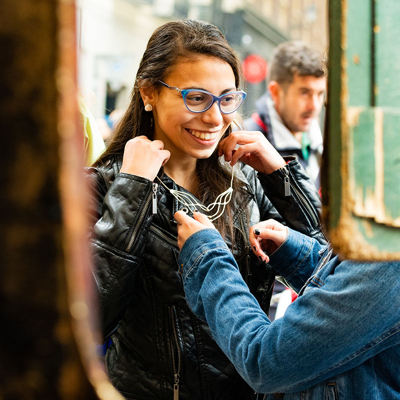 UD student trying on jewelry in foreign market