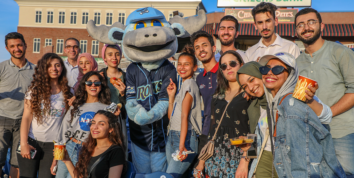 UD MEPI Student Leaders pose for a photo with the Blue Rocks Mascot, Rocky.