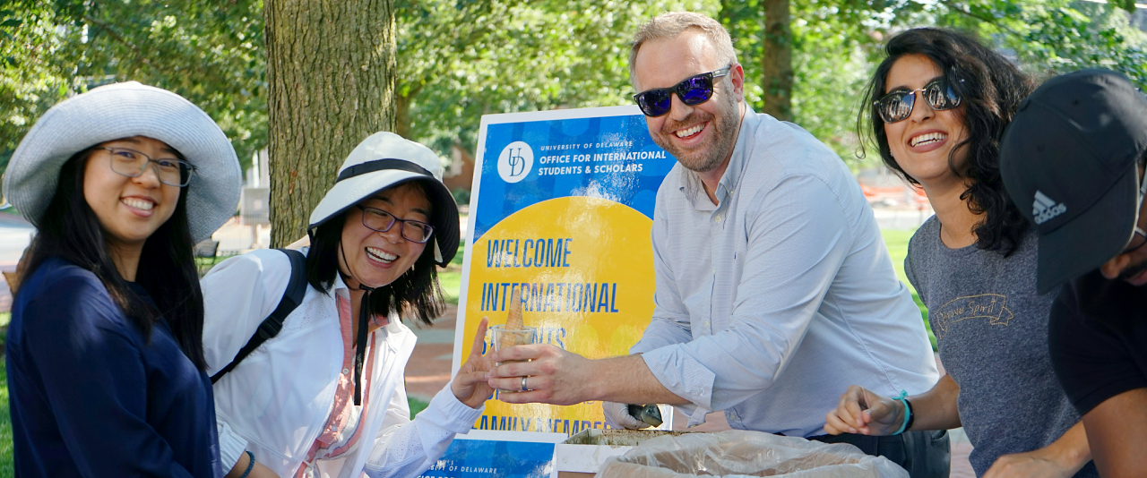 International students, scholars, and family join staff at the summer social
