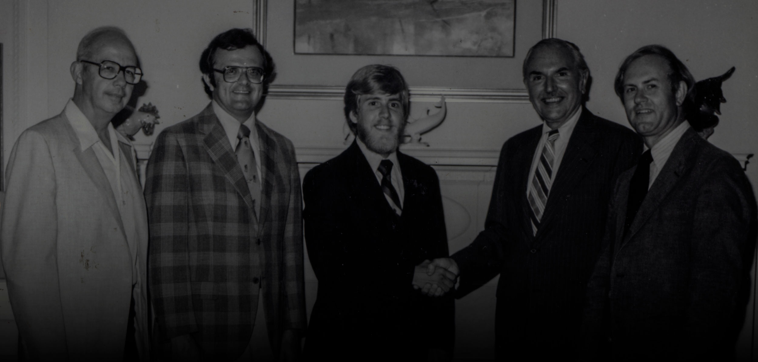 Honors Program officials handshake