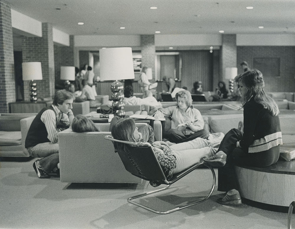 A historic image of students interacting in a lounge area