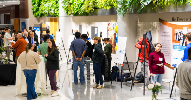 Photo of the students standing next to their posters during the blue hen innovation fest