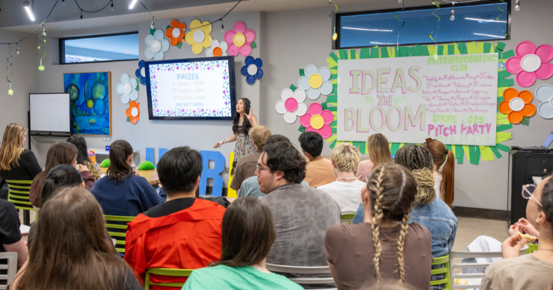 Student presenting in the front of a room