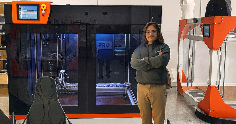 Rich Hayburn standing next to a 3D printer