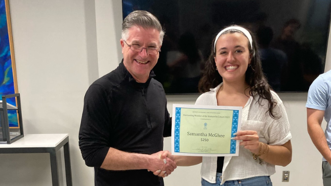 Vince DiFelice awarding Samantha McGhee with a certificate for Outstanding Member of the VentureOn Cohort 2023