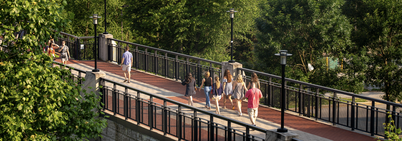 Students walking across Laird Campus bridge