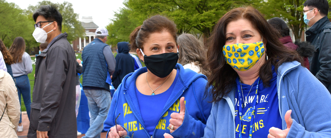 Two women with masks on UD Campus
