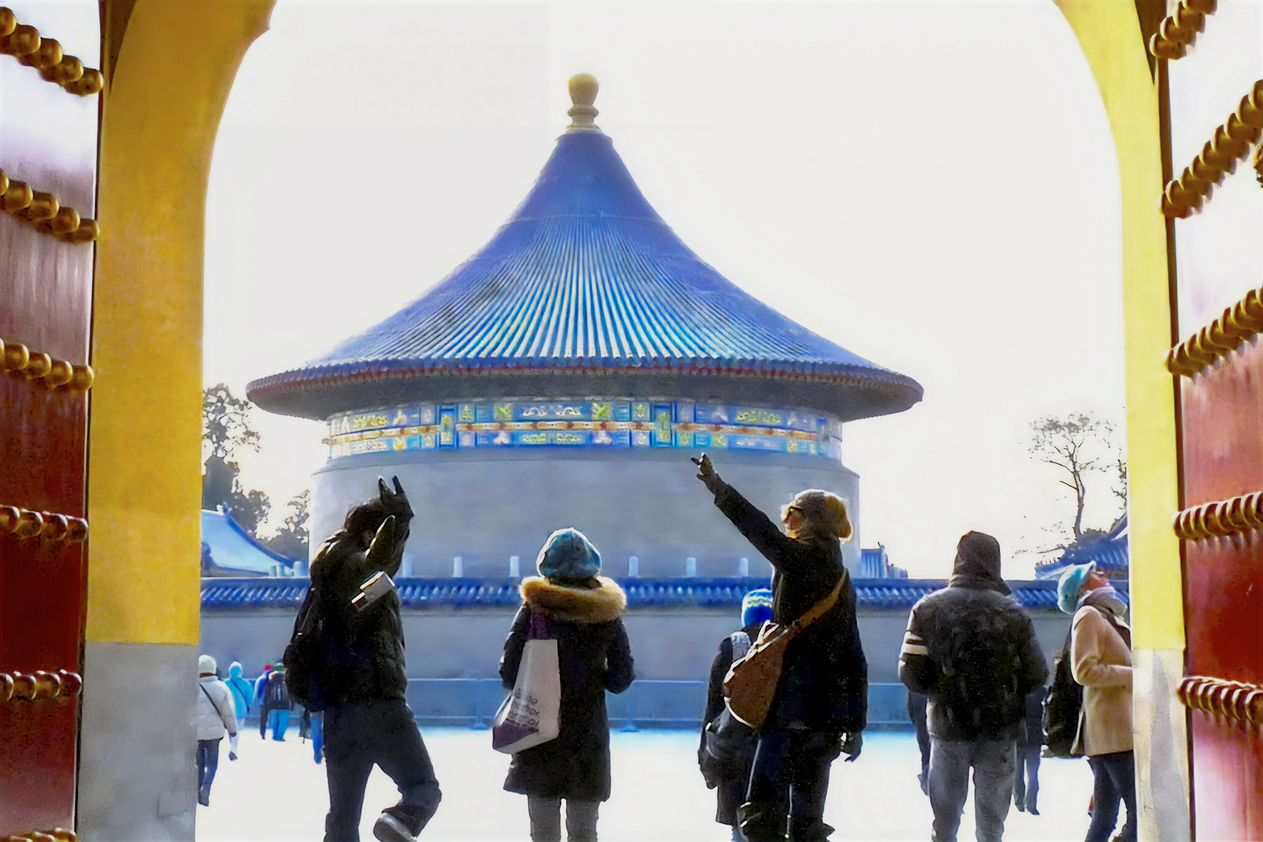 Students emerge from a doorway leading to the Temple of Heaven in Beiging, China. 
