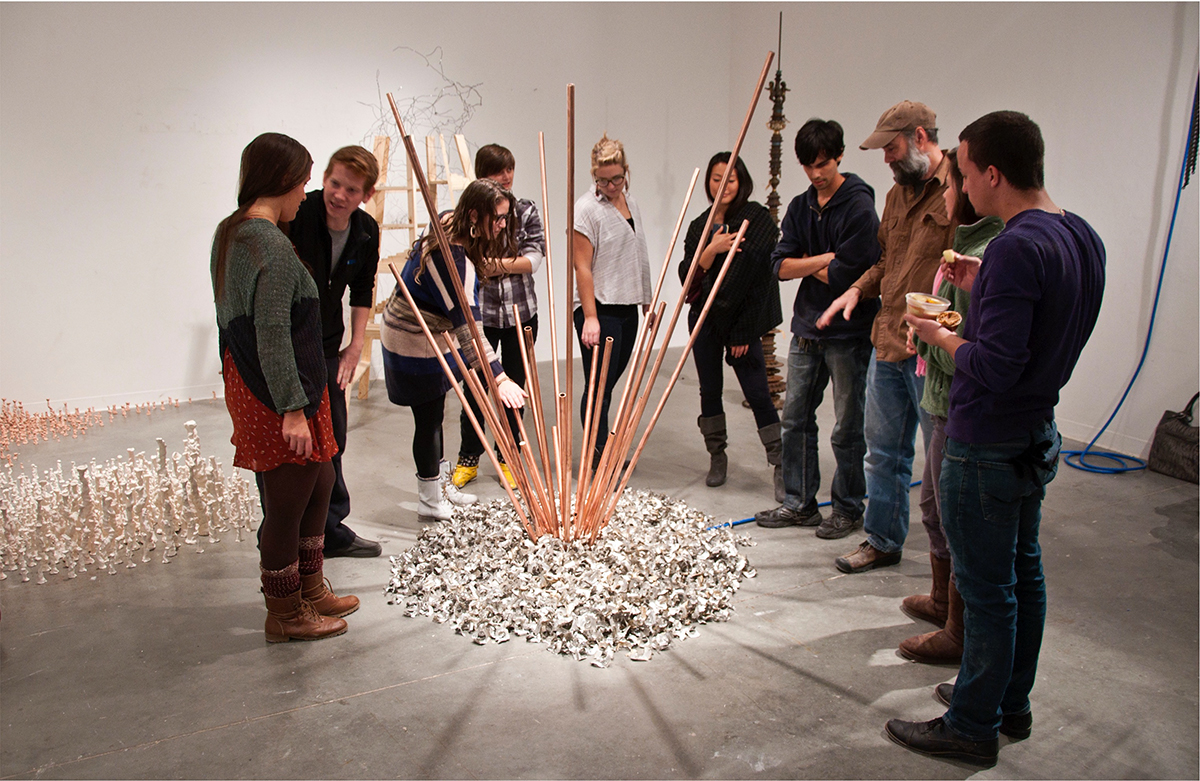 BFA Fine Arts students work on an interactive group art project in class involving craft sticks 