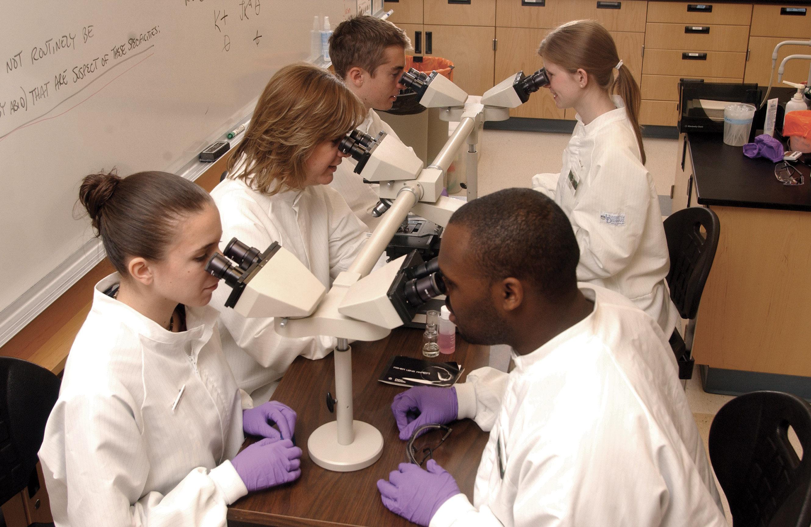 Medical Diagnostics students looking through microscopes