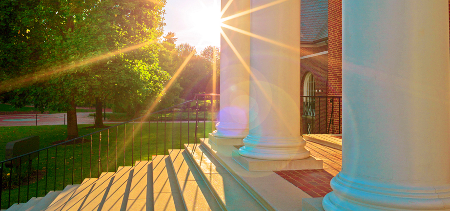Sun shining on campus building
