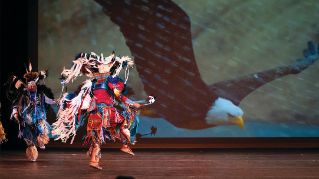 The performance group Indigenous Enterprise on stage performing.