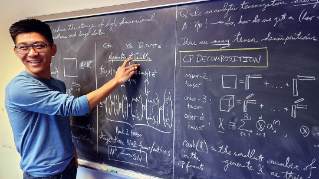 Joseph Nakao at the chalk board doing math. 