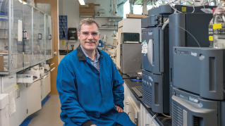 Professor Joseph Fox seated in lab.