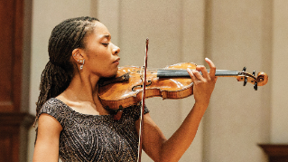 Graduate student violinist Nijoma Grevious playing the violin.