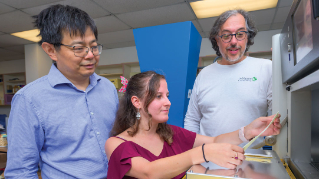UD Researchers looking at a fabric sample.