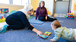 Michele Lobo interacts with a child.