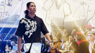 A model walks the runway while wearing a piece designed by Casey Tyler.