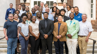 Group of staff and students from UD and Delaware State posing for a picture.