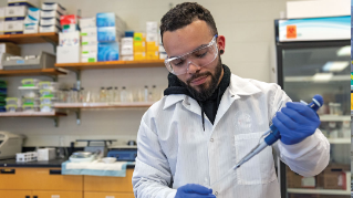 Jake Peluso-Vargas working in a lab setting.