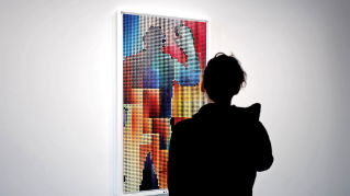 Andrew Zolty looks at one of his pieces.
