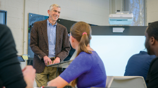 James Hiebert with students in the classroom.