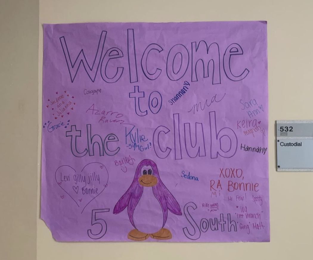 drawing on purple poster board of a penguin and "Welcome to the Club"