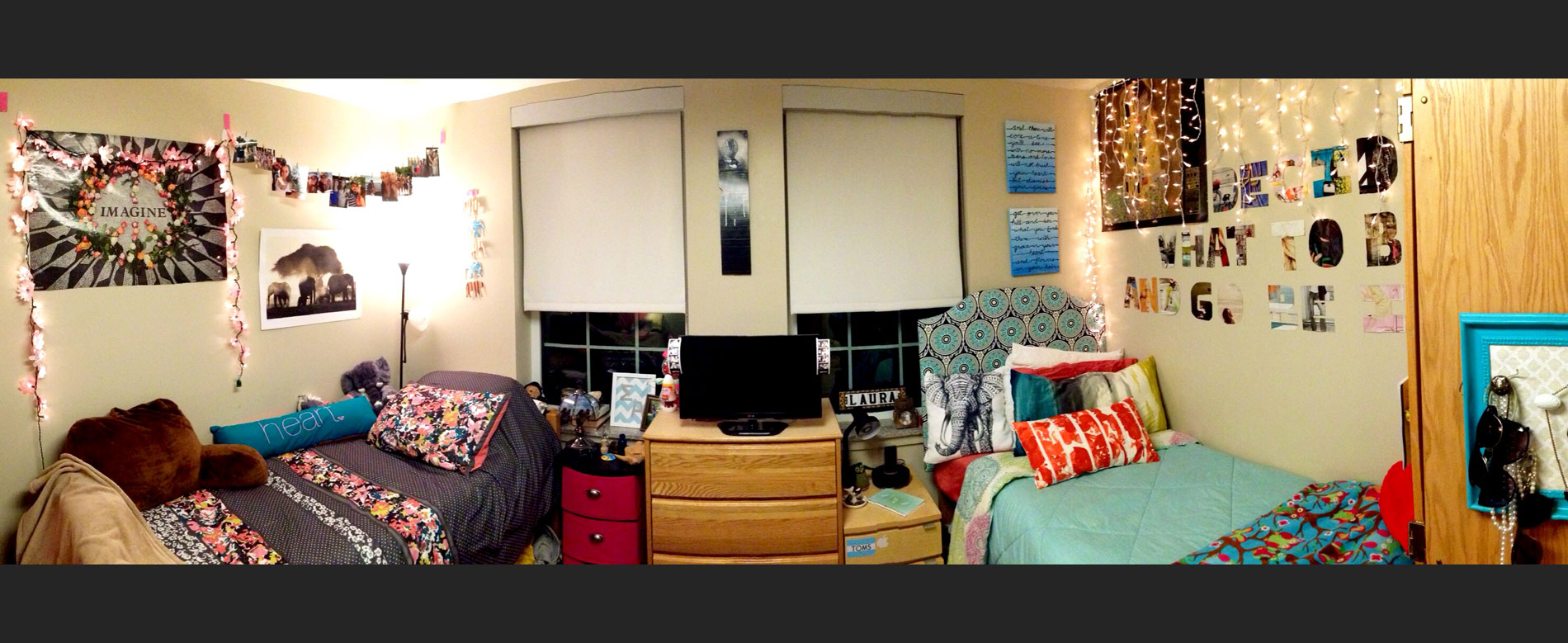 Dorm room with decorations and furnishings on two beds with a desk in between