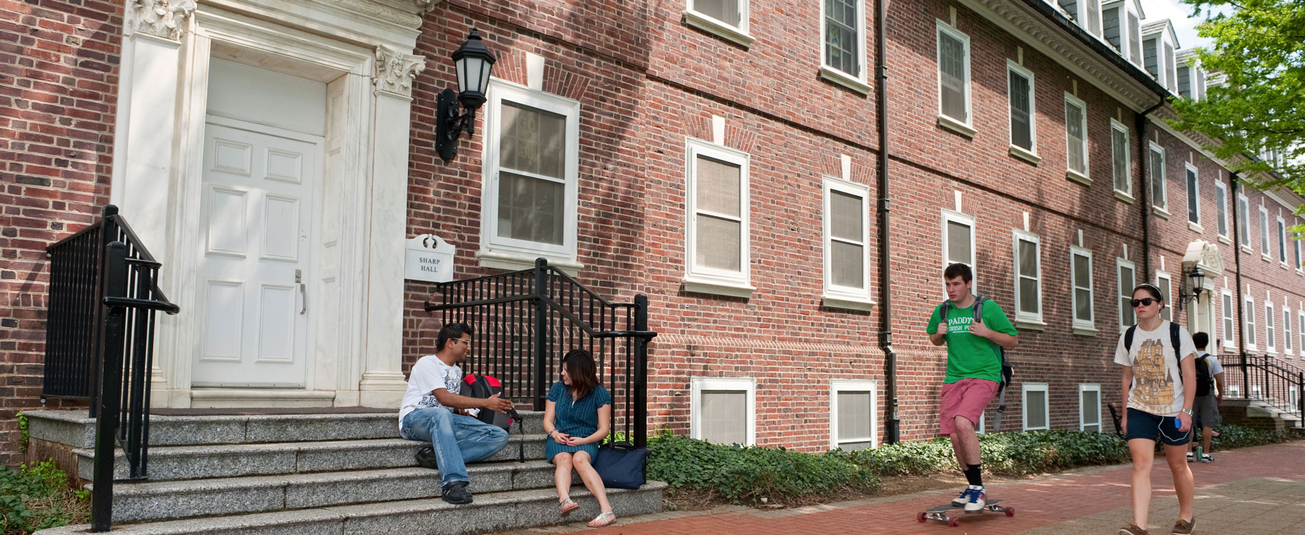 Students sit on steps outside North Central residence hall