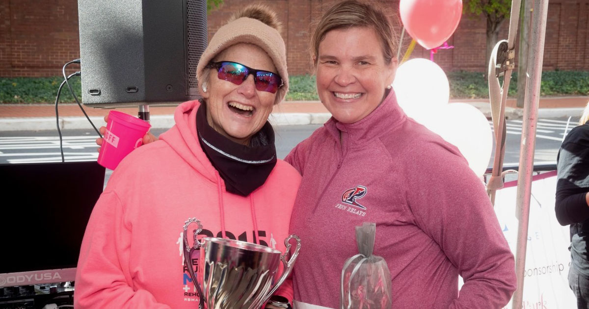 SHS staff holding Ashby Cup in pink clothing at Deer Park Goes Pink 5K