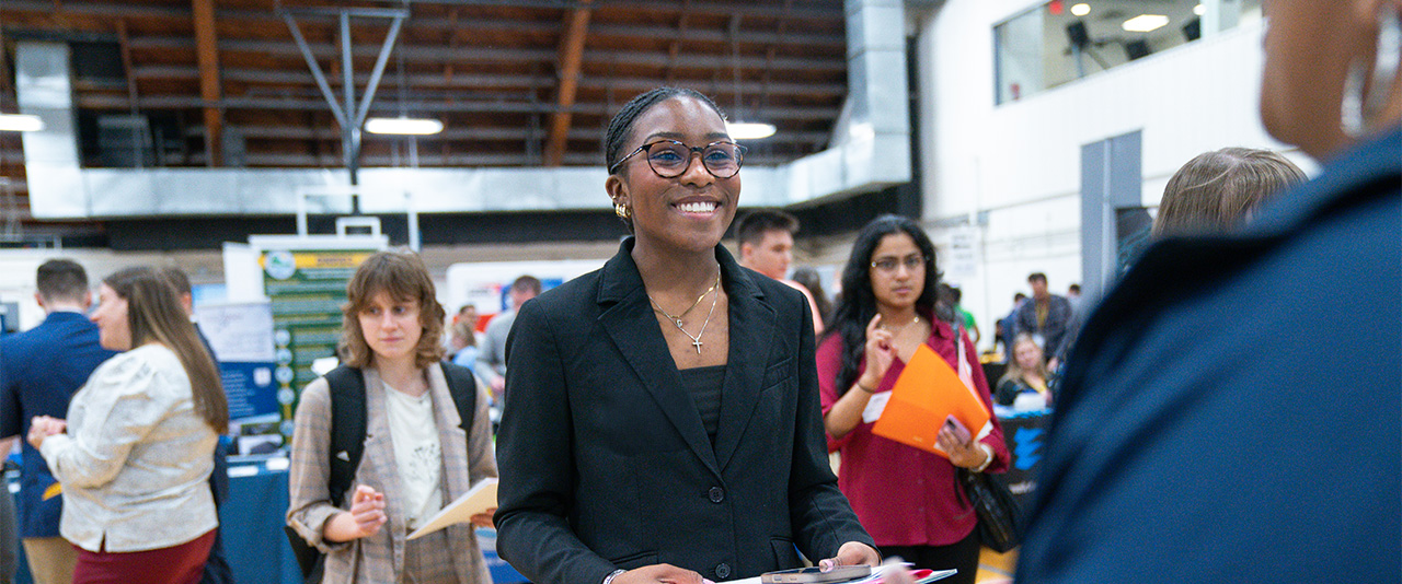 Student speaks with employer at a Career Fair