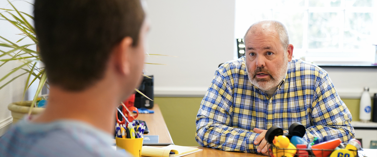 Community Standards & Conflict Resolution staff member consults with a student