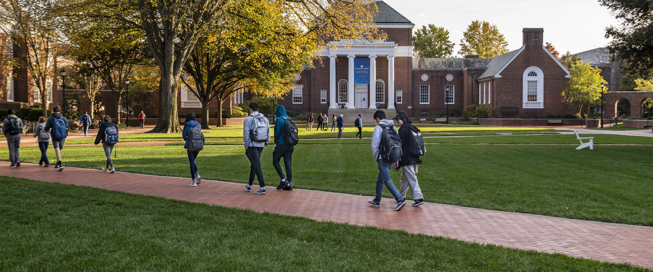 Students walking along the Green with Memorial Hall in the background