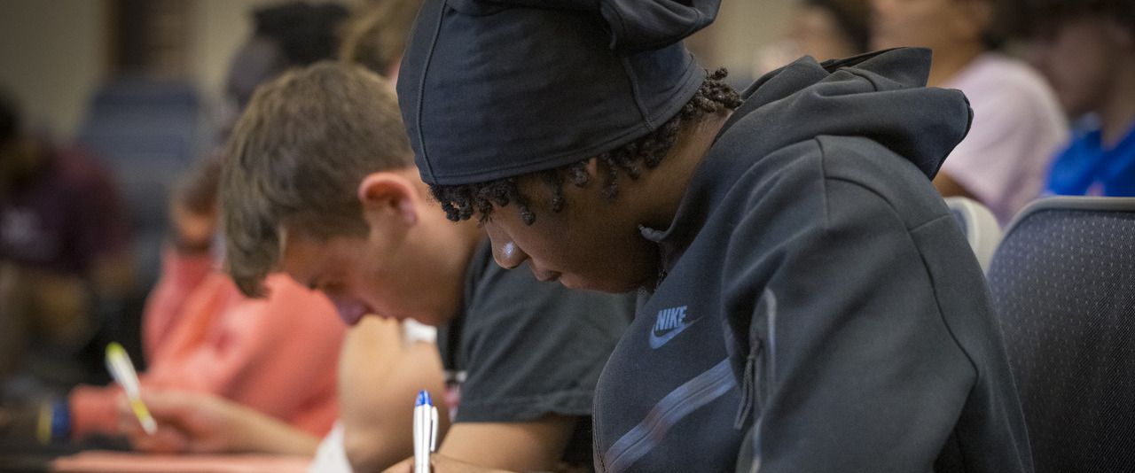 Students taking notes in a classroom