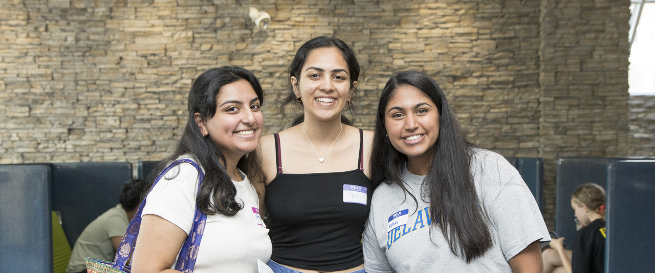 Three female students smiling for a photo
