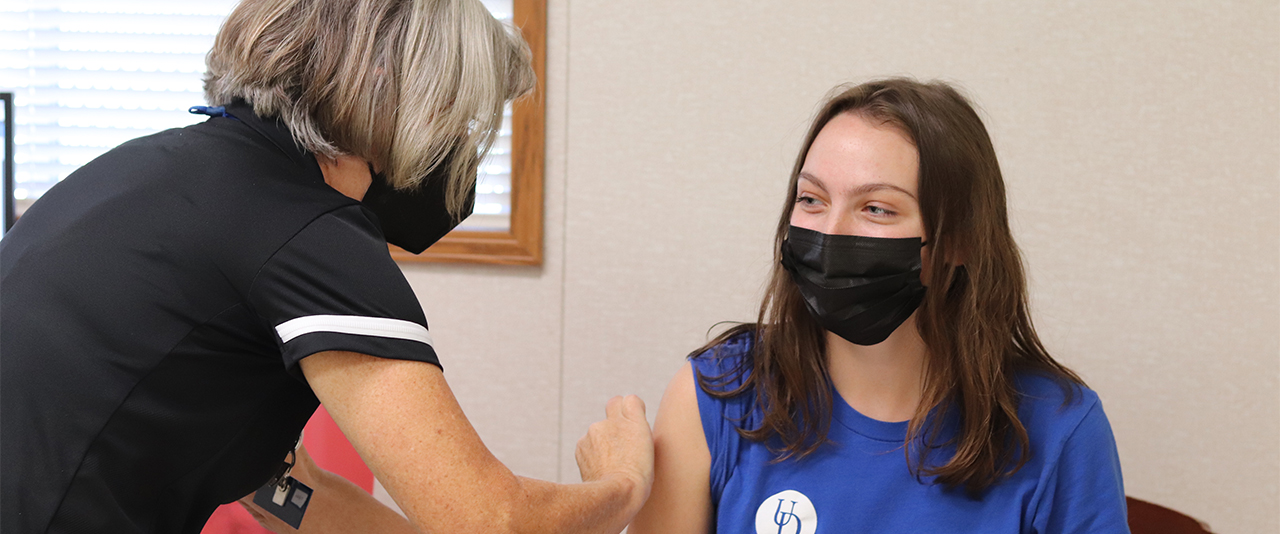 Student receives a flu shot at a Vaccine Clinic event