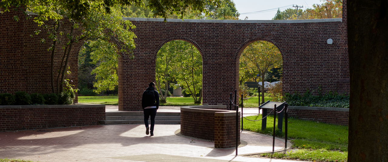 unidentified student walks through the arches at Memorial Hall