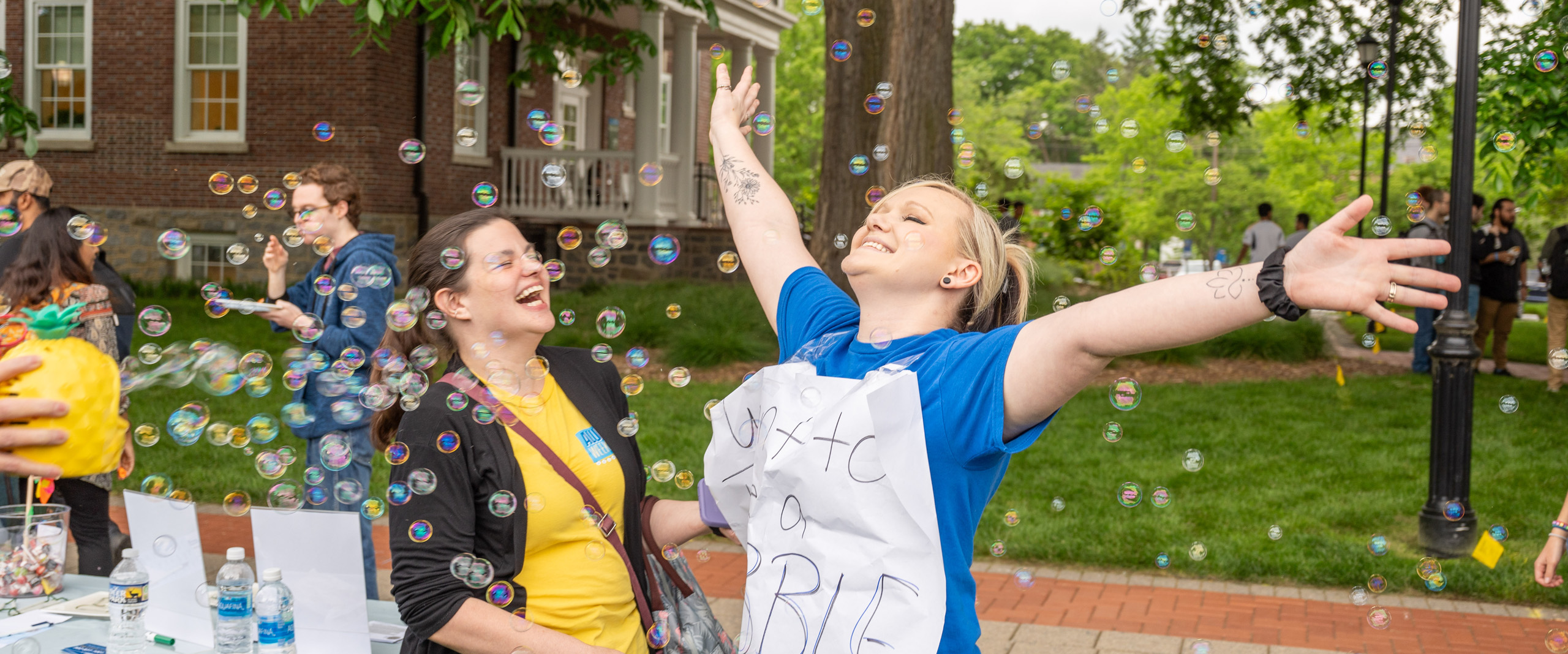 students enjoy being surrounded by bubbles at the De-Stress Fest on the Green.
