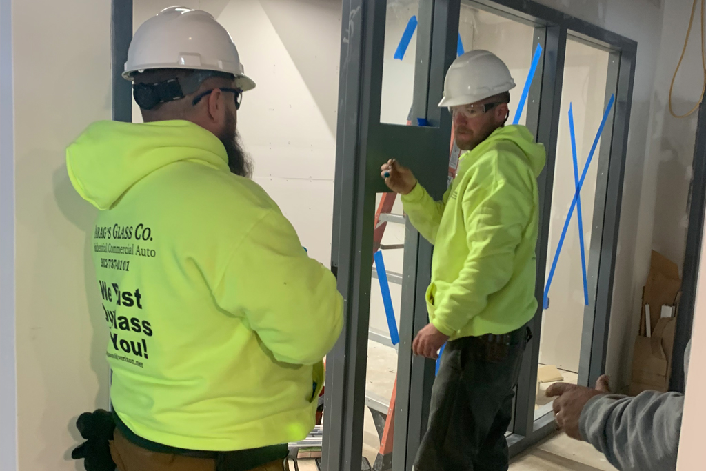 workers install glass in the CIE