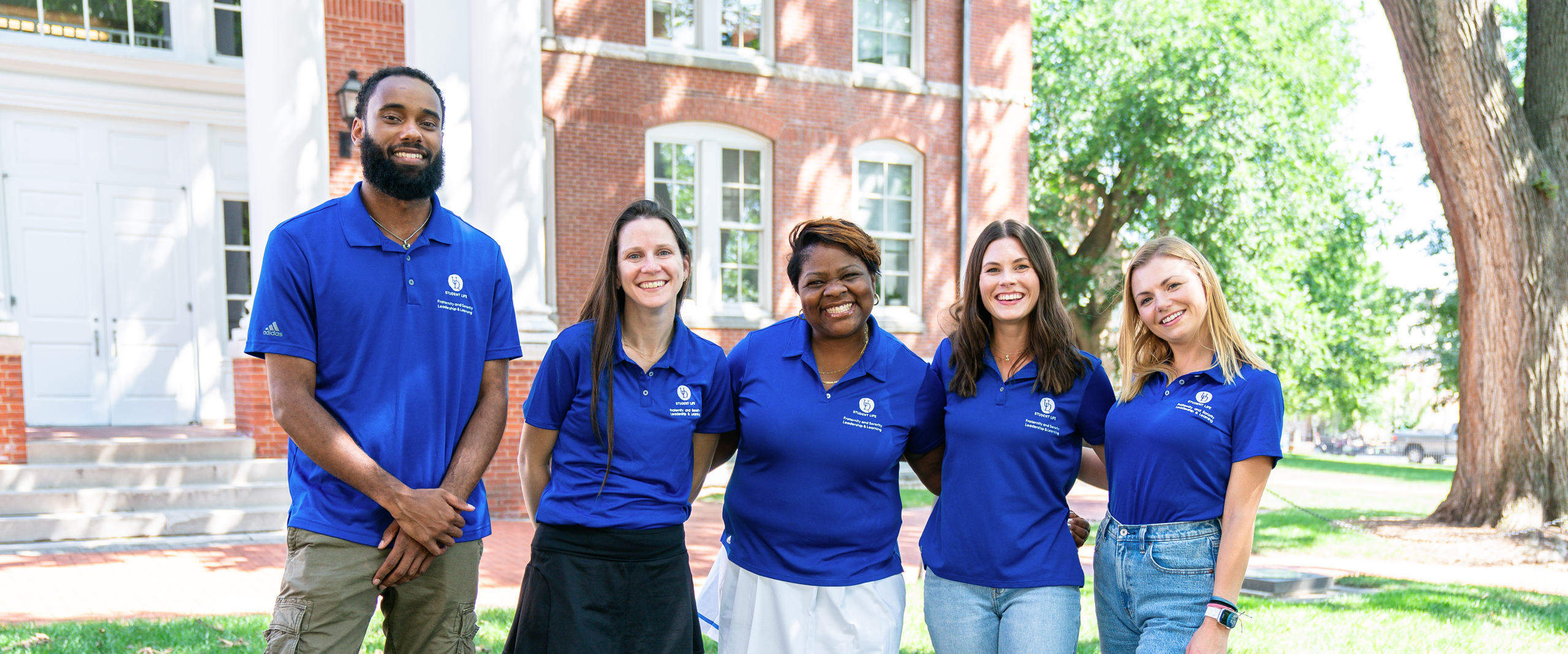 an outdoor group photo of FSLL's five staff members