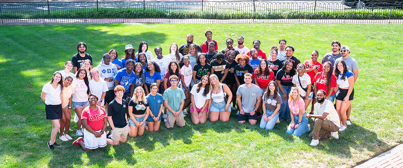 Fraternity and sorority members pose with FSLL staff for a group photo