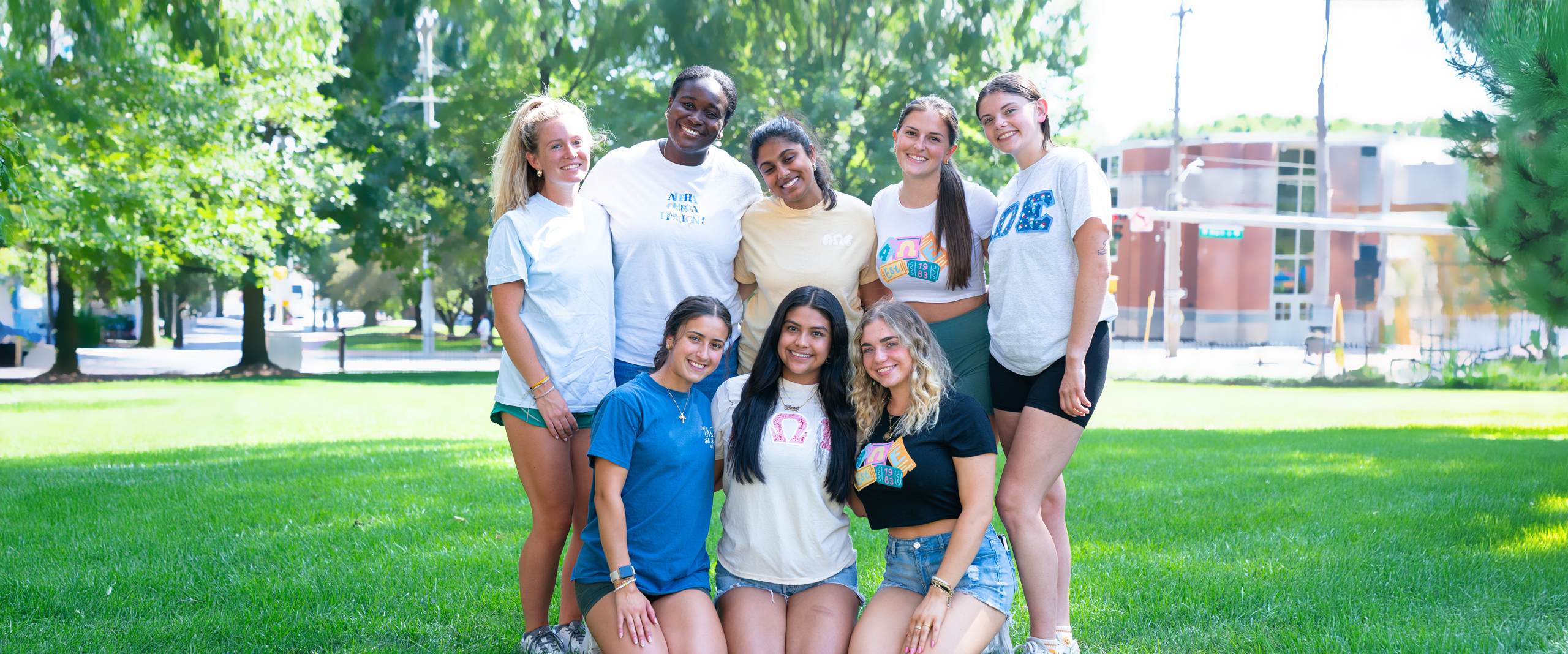 a group of students in SIGC poses in front of Trabant Student Center