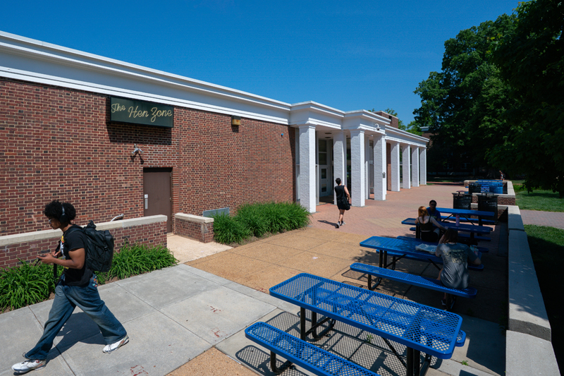 Perkins back patio with blue picnic tables with benches